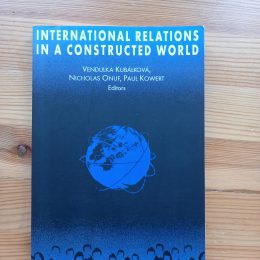 blue cover with a far away image of the globe as if from space the picture was taken. outlines of people at the bottom of the cover page to, suggestive of something.